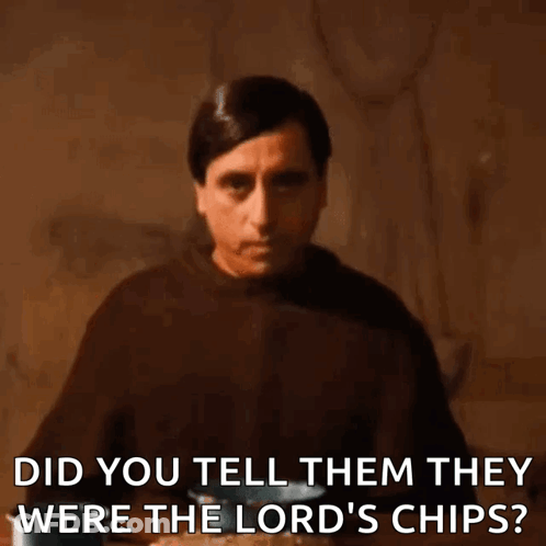 A Man In A Brown Robe Is Sitting At A Table And Asking If They Were Lord 'S Chips . GIF