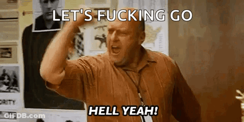 A Man In A Brown Shirt Is Screaming And Holding His Fist In The Air . GIF