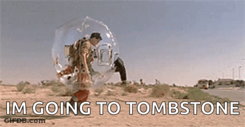 A Man In A Bubble Is Walking Down A Desert Road . GIF