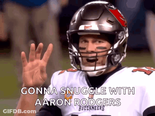 A Man In A Buccaneers Jersey Is Waving His Hand GIF