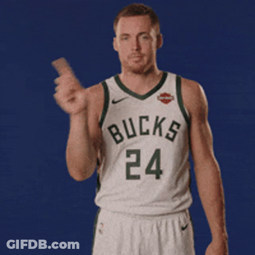 A Man In A Bucks Jersey Is Holding Something GIF
