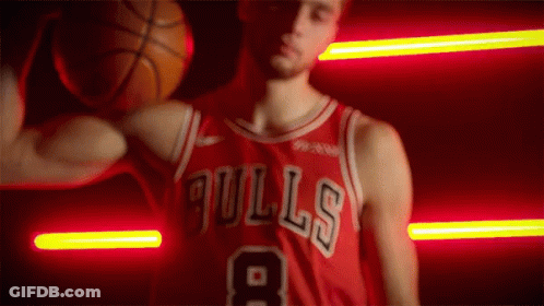 A Man In A Bulls Jersey Holds A Basketball Over His Head GIF