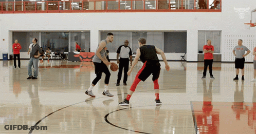 A Man In A Bulls T-Shirt Is Playing Basketball GIF