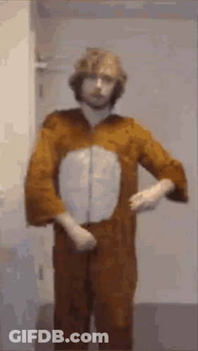 A Man In A Bunny Costume Is Standing In Front Of A Door . GIF