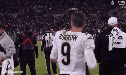 A Man In A Burrow 9 Jersey Stands On A Football Field GIF