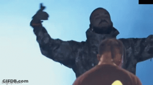 A Man In A Camo Jacket Is Giving A Middle Finger In Front Of A Blue Sky .. GIF