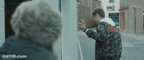 A Man In A Camo Jacket Is Standing Next To A Woman GIF