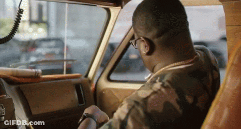 A Man In A Camo Shirt Is Driving A Vehicle GIF