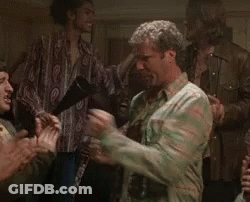 A Man In A Camouflage Shirt Is Dancing In A Crowd Of People . GIF