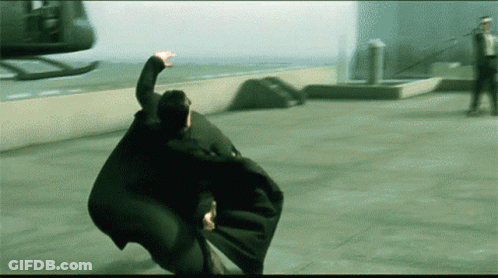 A Man In A Cape Is Flying Through The Air GIF