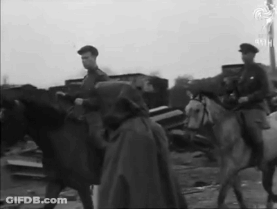 A Man In A Cape Is Riding A White Horse GIF