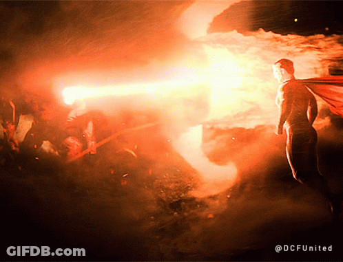 A Man In A Cape Is Standing In Front Of A Fire With The Hashtag @Dcfunited GIF