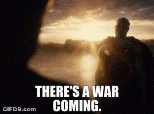 A Man In A Cape Is Standing In Front Of A Sunset With The Words There 'S A War Coming . GIF