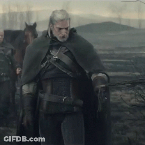 A Man In A Cape Is Standing Next To A Horse GIF