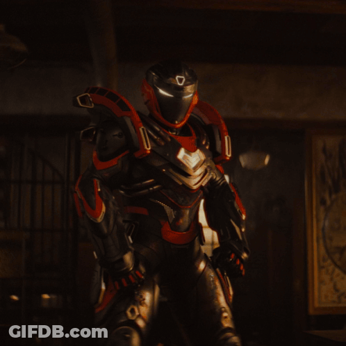A Man In A Cape Stands In A Dark Room GIF