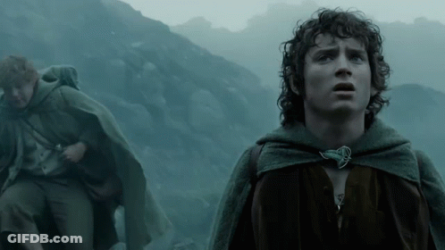 A Man In A Cape Stands In Front Of A Mountain Looking Up GIF