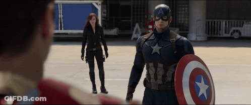 A Man In A Captain America Costume Holds A Shield GIF
