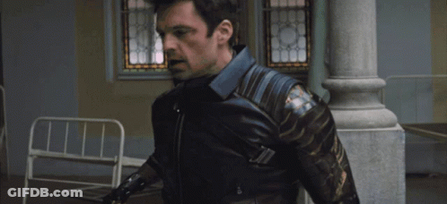 A Man In A Captain America Costume Is Being Held By Another Person GIF