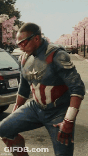 A Man In A Captain America Costume Is Kneeling Down GIF