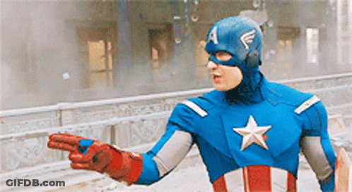 A Man In A Captain America Costume Is Pointing To Something GIF