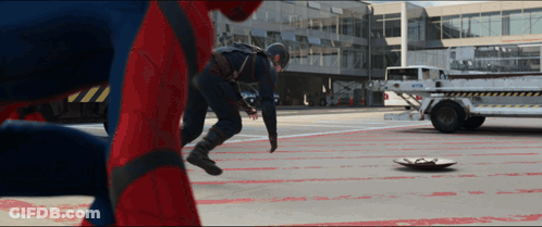 A Man In A Captain America Costume Is Standing Next To A Spider Man GIF