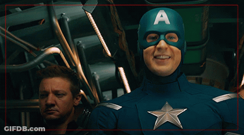 A Man In A Captain America Costume With An A On His Cape GIF