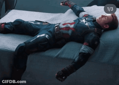 A Man In A Captain America Uniform Is Laying On A Bed With The Number 1/3 On The Bottom GIF