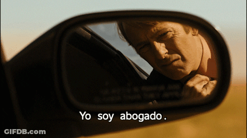 A Man In A Car Is Reflected In A Rear View Mirror With The Words Yo Soy Abogado GIF