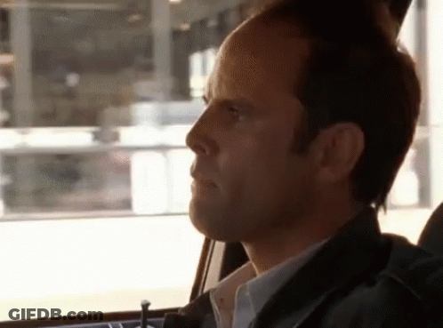 A Man In A Car Looking Out The Window GIF