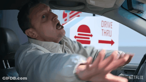 A Man In A Car Screaming In Front Of A Drive Thru Sign GIF