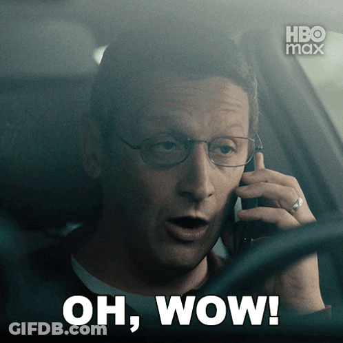 A Man In A Car Talking On A Cell Phone With The Words Oh Wow On The Bottom GIF