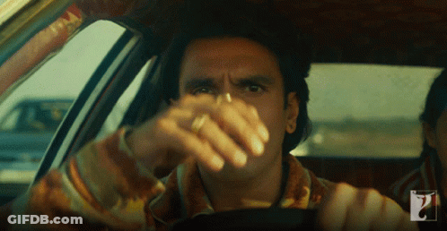 A Man In A Car With A Ring On His Finger Looks At The Camera GIF