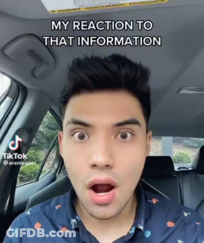 A Man In A Car With A Surprised Look On His Face Says " My Reaction To That Information " On The Bottom GIF