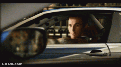 A Man In A Car With A Tattoo On His Arm GIF
