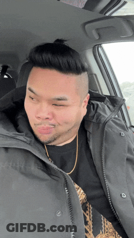 A Man In A Car With His Eyes Closed Wearing A Black Jacket GIF