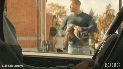 A Man In A Car With The Word Reacher On The Steering Wheel GIF