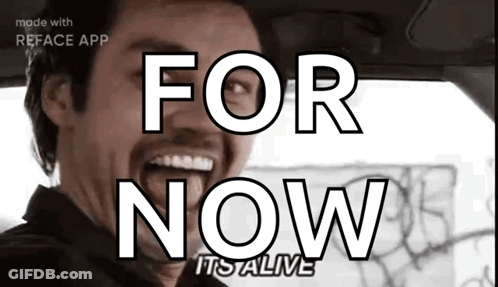 A Man In A Car With The Words For Now It 'S Alive On His Face GIF