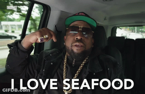A Man In A Car With The Words I Love Seafood On The Screen GIF