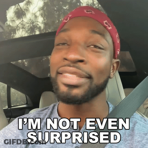A Man In A Car With The Words I 'M Not Even Surprised On The Bottom GIF