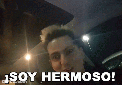 A Man In A Car With The Words Soy Hermoso Written Below Him GIF