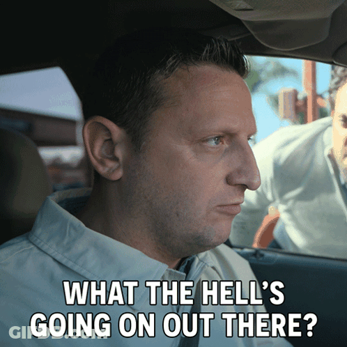 A Man In A Car With The Words What The Hell 'S Going On Out There Written Below Him GIF