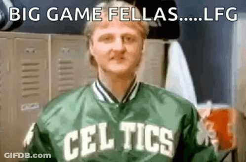 A Man In A Celtics Jacket Is Standing In A Locker Room . GIF