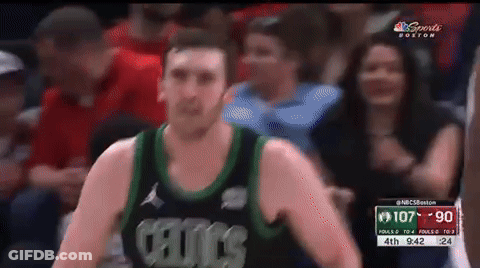 A Man In A Celtics Jersey Stands In Front Of A Crowd During A Basketball Game GIF