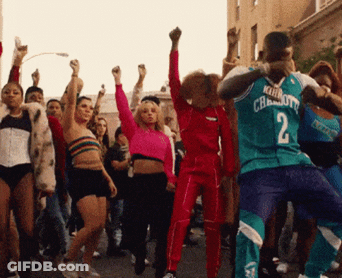 A Man In A Charlotte Jersey Is Dancing With A Crowd GIF