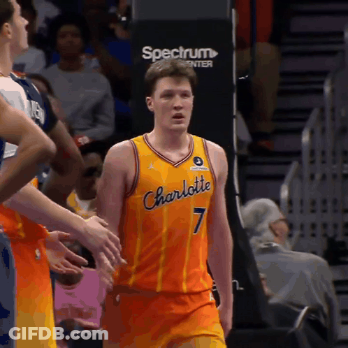 A Man In A Charlotte Jersey Stands In Front Of A Spectrum Sign GIF