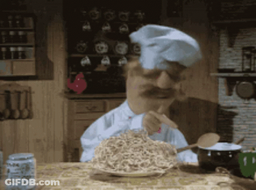A Man In A Chef 'S Hat Is Eating Noodles With A Fork GIF