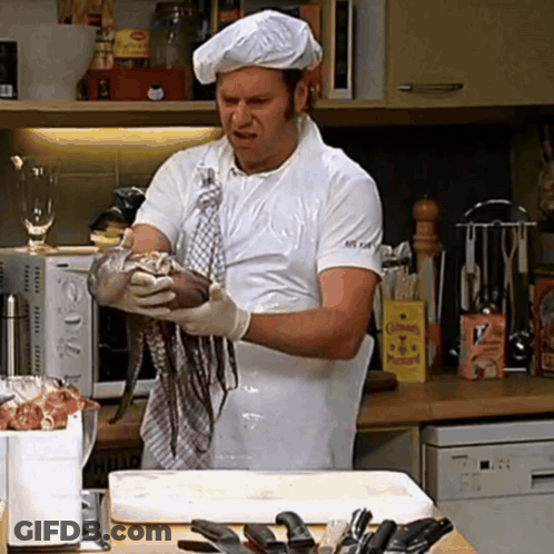 A Man In A Chef 'S Hat Is Holding A Large Octopus In His Hands GIF
