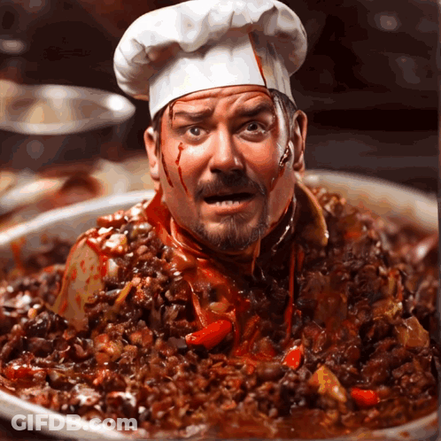 A Man In A Chef 'S Hat With His Head In A Pan Of Food GIF