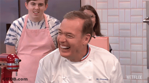A Man In A Chef 'S Uniform Is Laughing In Front Of A Mixer And A Sign That Says Netflix GIF