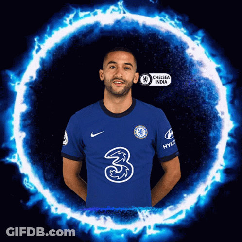 A Man In A Chelsea India Jersey Stands In Front Of A Blue Fire Circle GIF